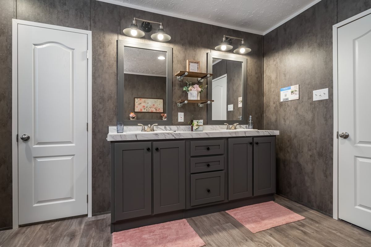 004a7b60-b098-4ee4-a479-4eede128bc0a A bathroom with two sinks and a mirror.