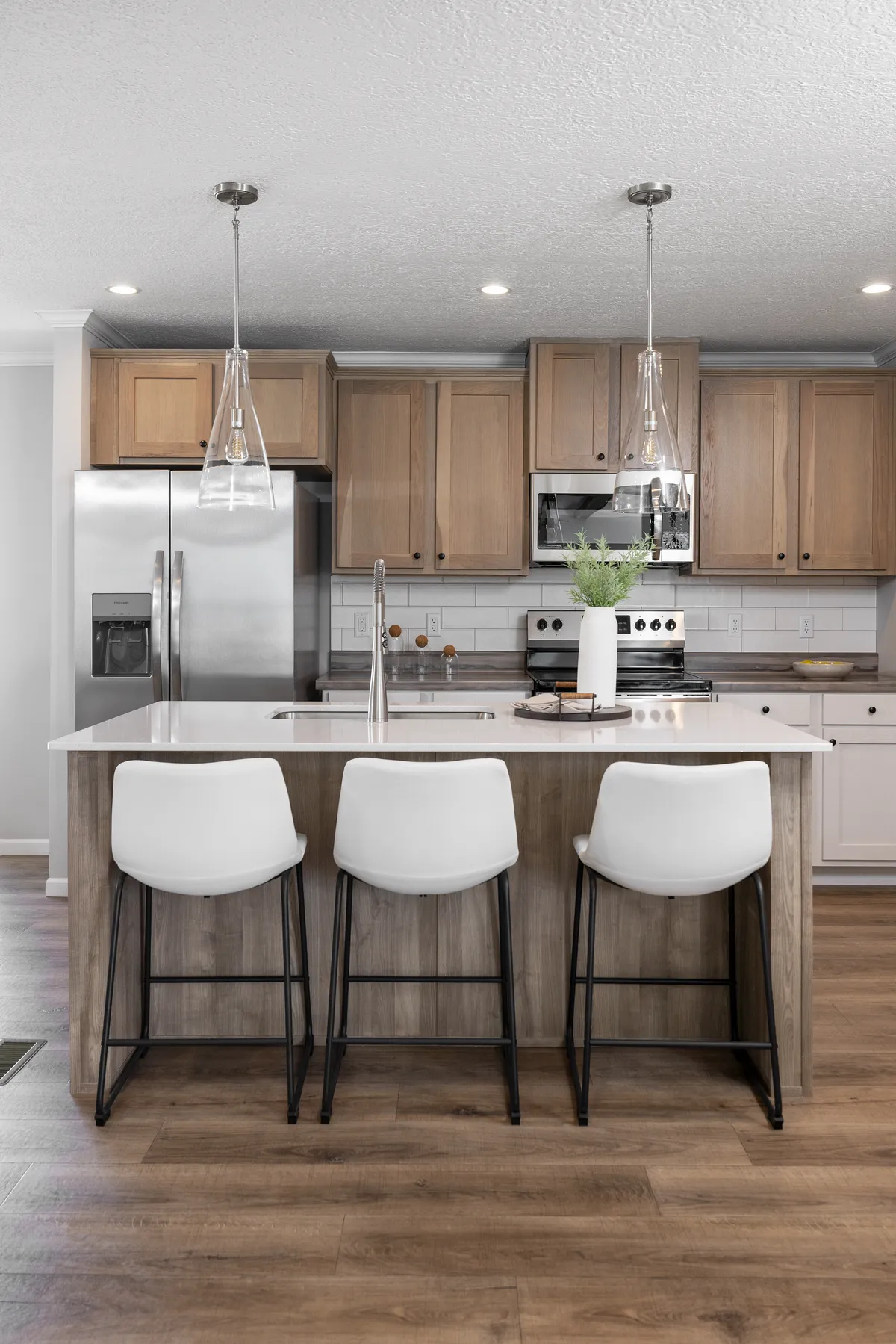 A kitchen with hardwood floors and a center island.