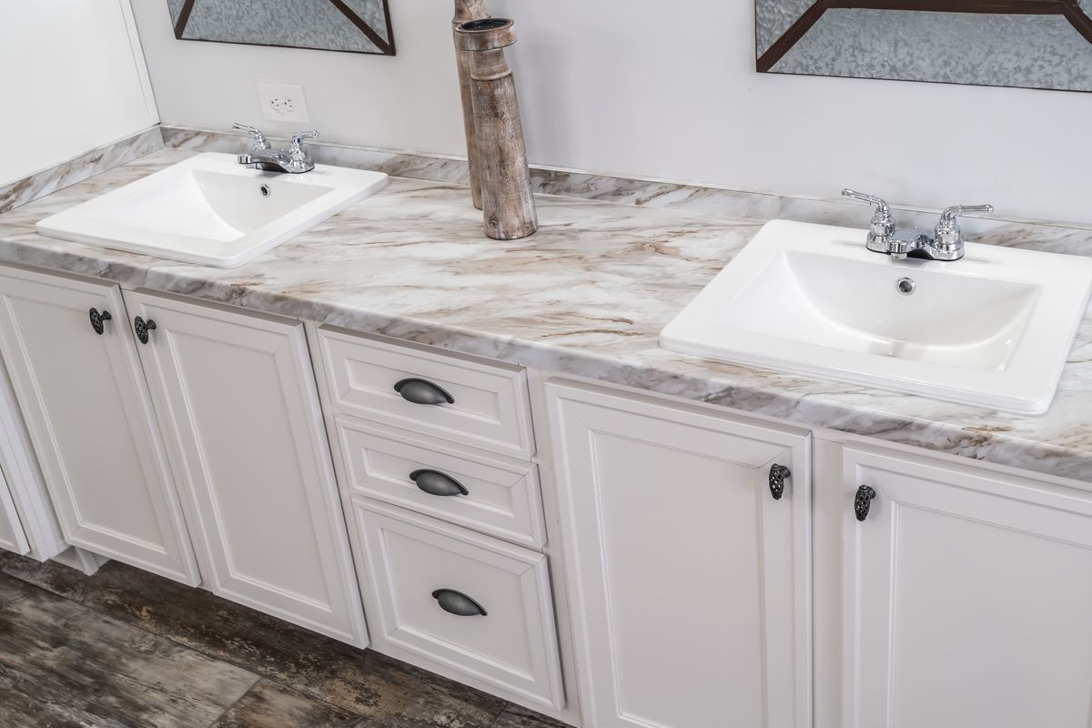 30CEE16682AH
Clayton Waycross Facility 930 Two sinks in a bathroom with marble counter tops.