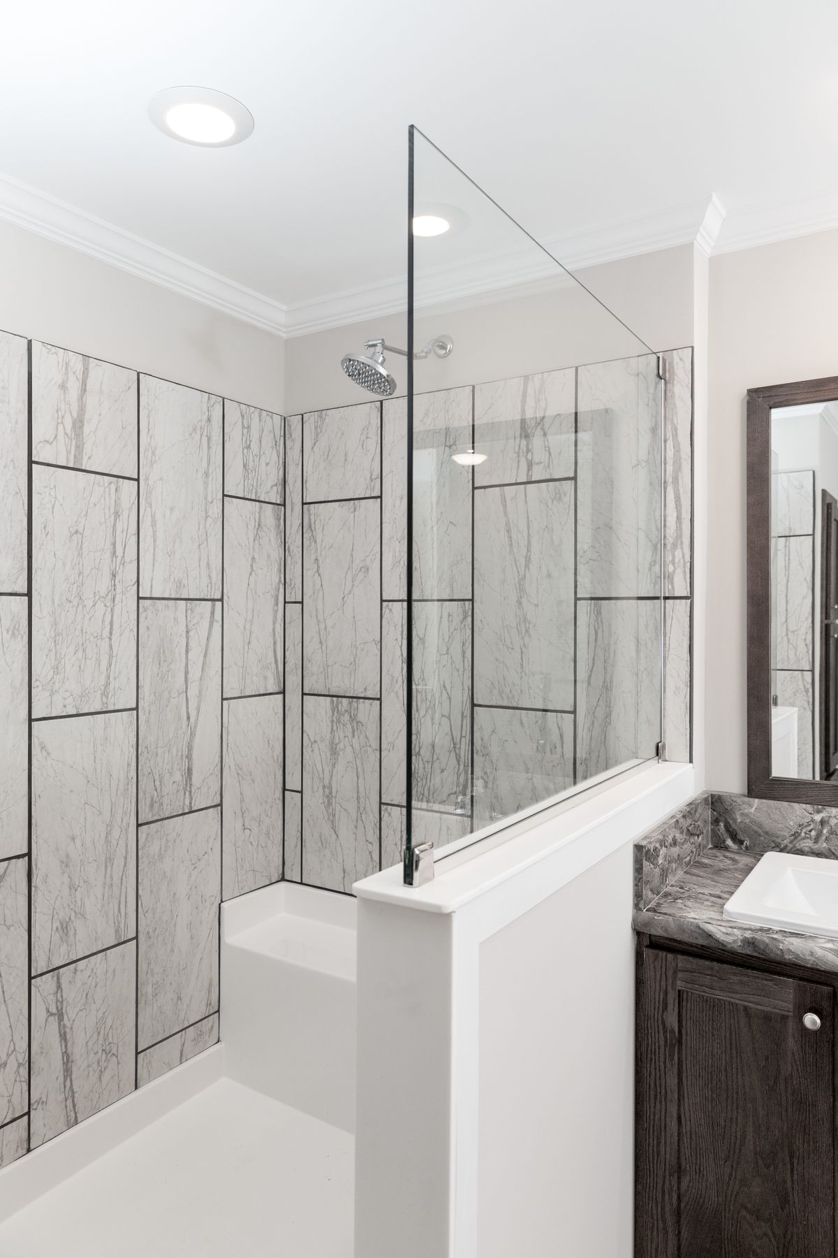 0b061f7f-f0d7-46d9-8965-69952c9507e4 A bathroom with a glass shower stall and marble counter tops.