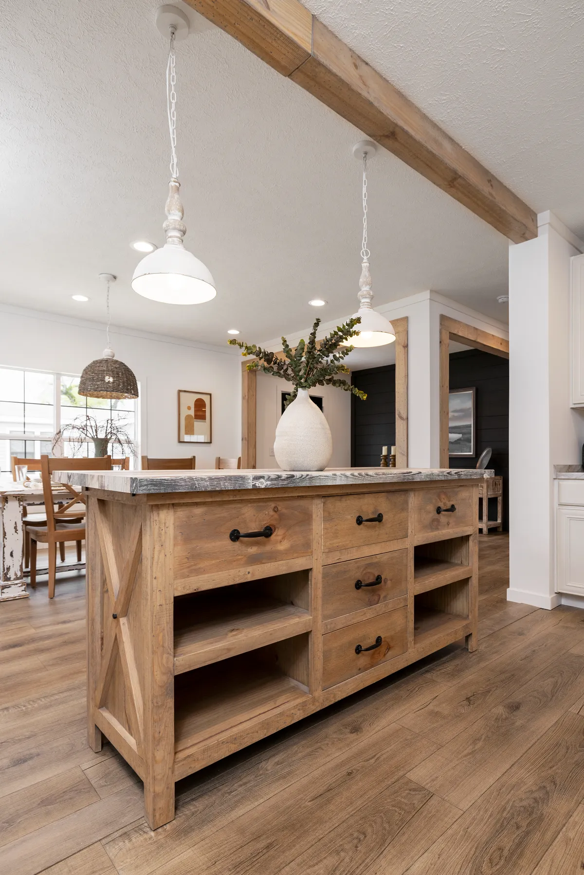 0fd5547c-0dd2-473f-845e-25723a33b241 A kitchen with wood floors and a wooden island.
