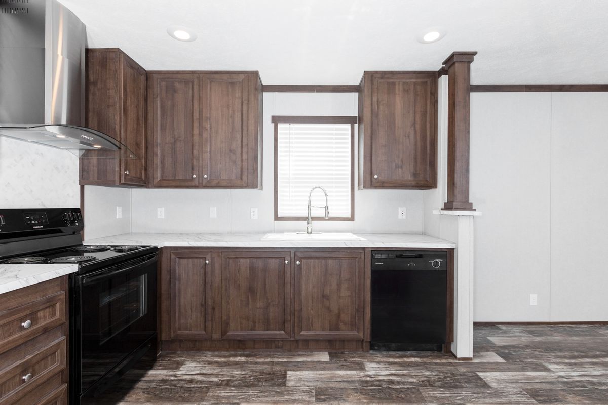 A kitchen with wood cabinets and stainless steel appliances.