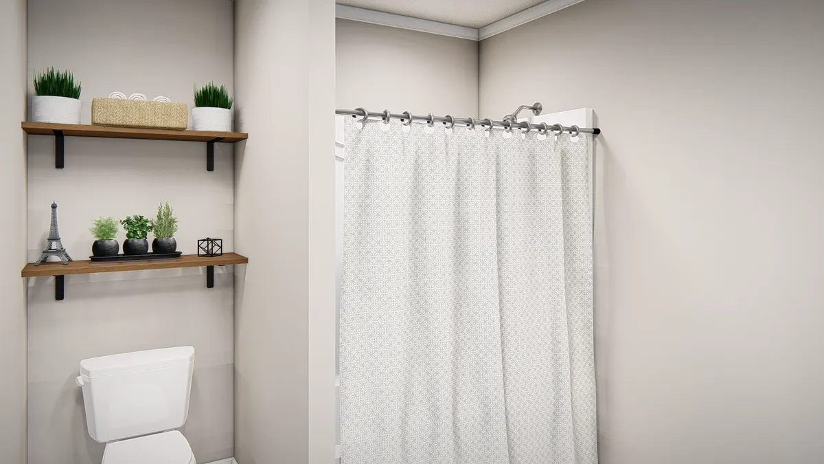 A bathroom with a toilet, sink and shower curtain.