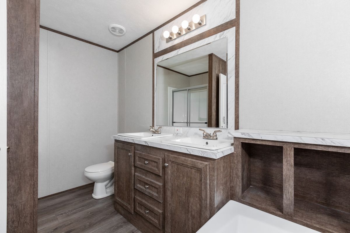 1e7a9a11-6720-4d14-a90a-9d5740b1408a A bathroom with a toilet and sink.