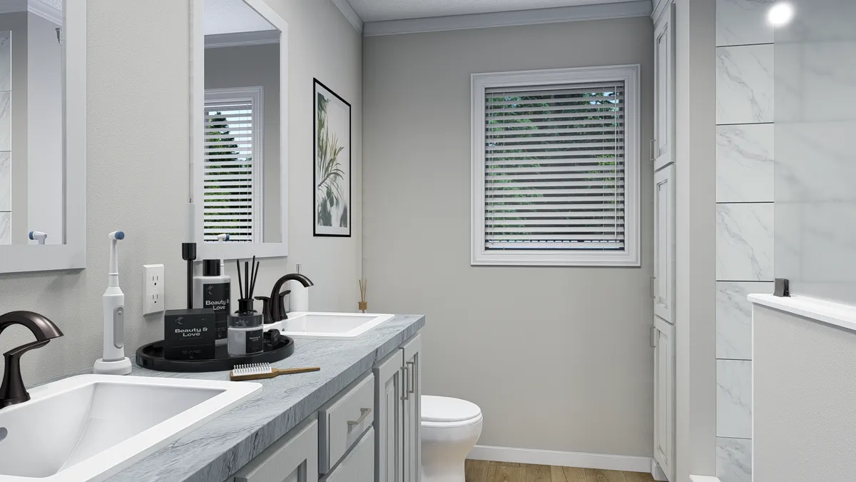 A bathroom with a sink, mirror, and toilet.