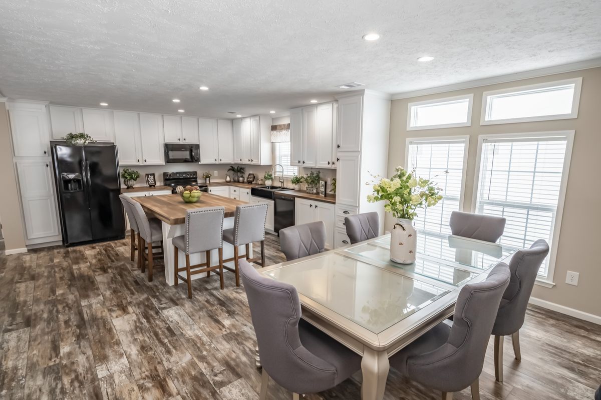 2d12b889-3230-410d-aacf-40b3a964b4d7 A kitchen and dining room in a mobile home.