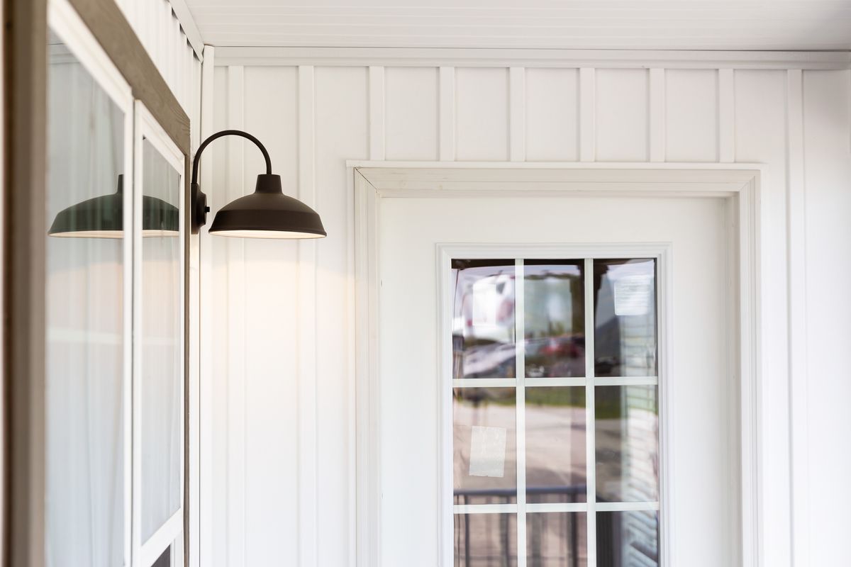 376c01df-8343-42cf-8e20-c31b0fc04630 A white door with a light on it.