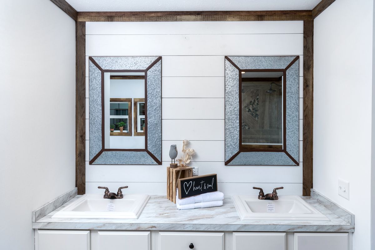 A bathroom with two sinks and mirrors.