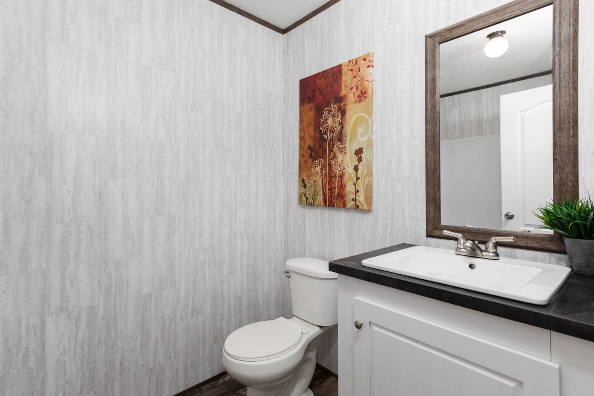 A bathroom with a toilet and sink.