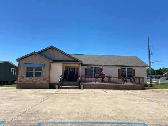 A mobile home for sale in a parking lot.