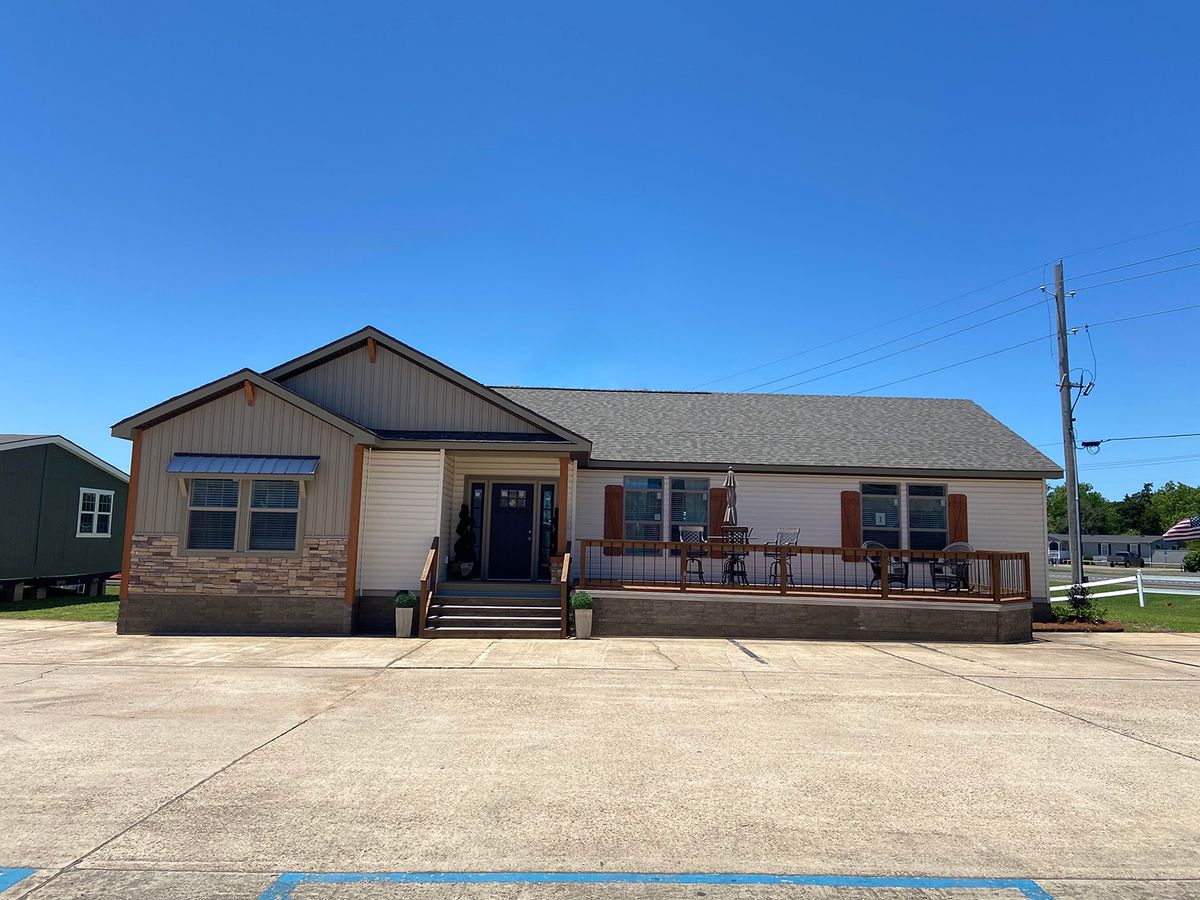 A mobile home for sale in a parking lot.