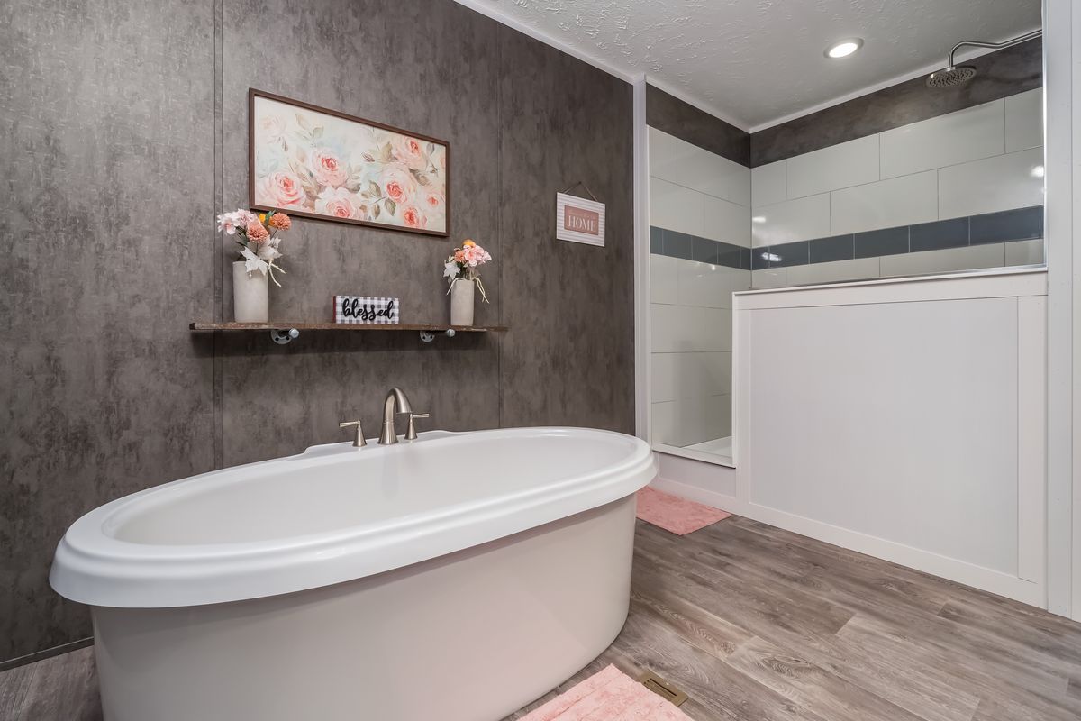 3a78432e-b41f-4a76-ac59-96335656d3c9 A bathroom with a tub and a shower.