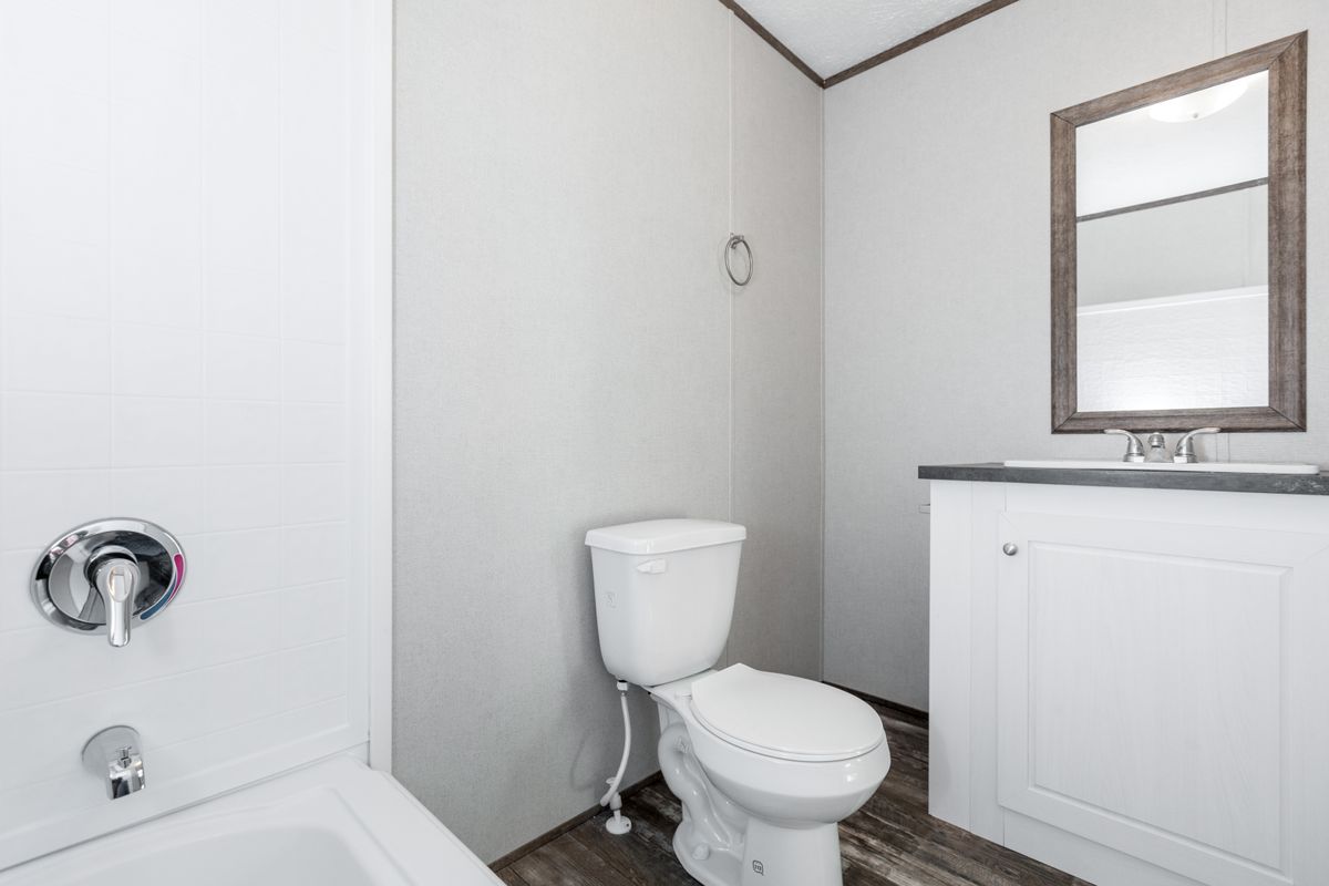 3f843e7d-68c0-49fe-98b4-6f10be9b28d1 A white bathroom with a toilet and sink.