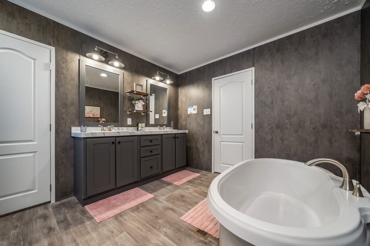 40f7051f-a8ef-4c4f-a96c-e25c47c52e0e A bathroom with a tub and a sink.