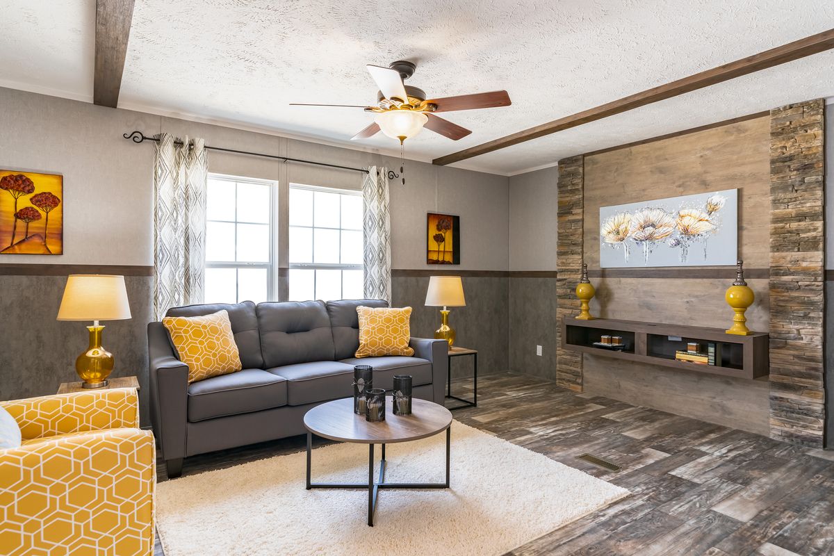43394ca2-1a61-4ecc-b7f1-fed4627107f3 A living room in a mobile home with vibrant yellow accents.