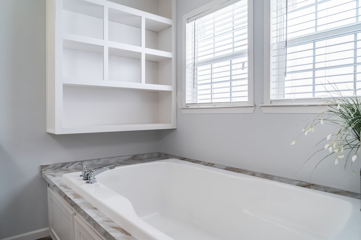30CEE16682AH
Clayton Waycross Facility 930 A bathroom with a white tub and shelves.