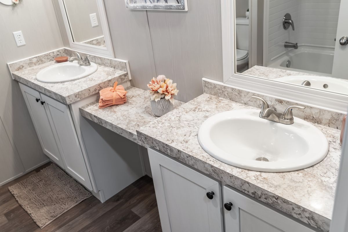 A bathroom with two sinks and a mirror is a functional and stylish space for daily grooming routines and personal care. The presence of two sinks allows for convenience, especially in households with multiple individuals sharing the same