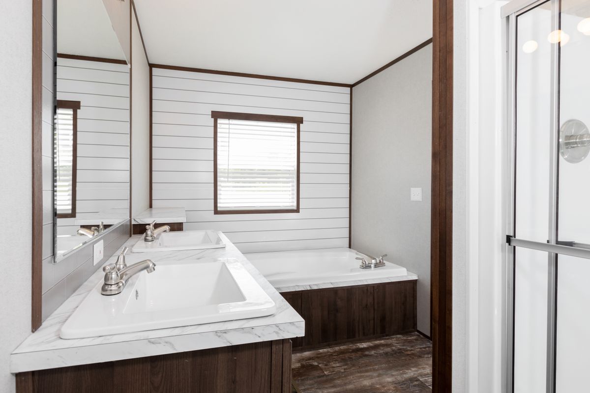 A bathroom with a sink, toilet and shower.