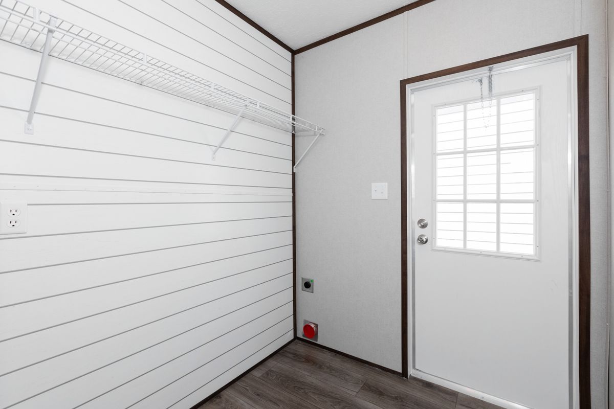 A small room with white walls and a door.