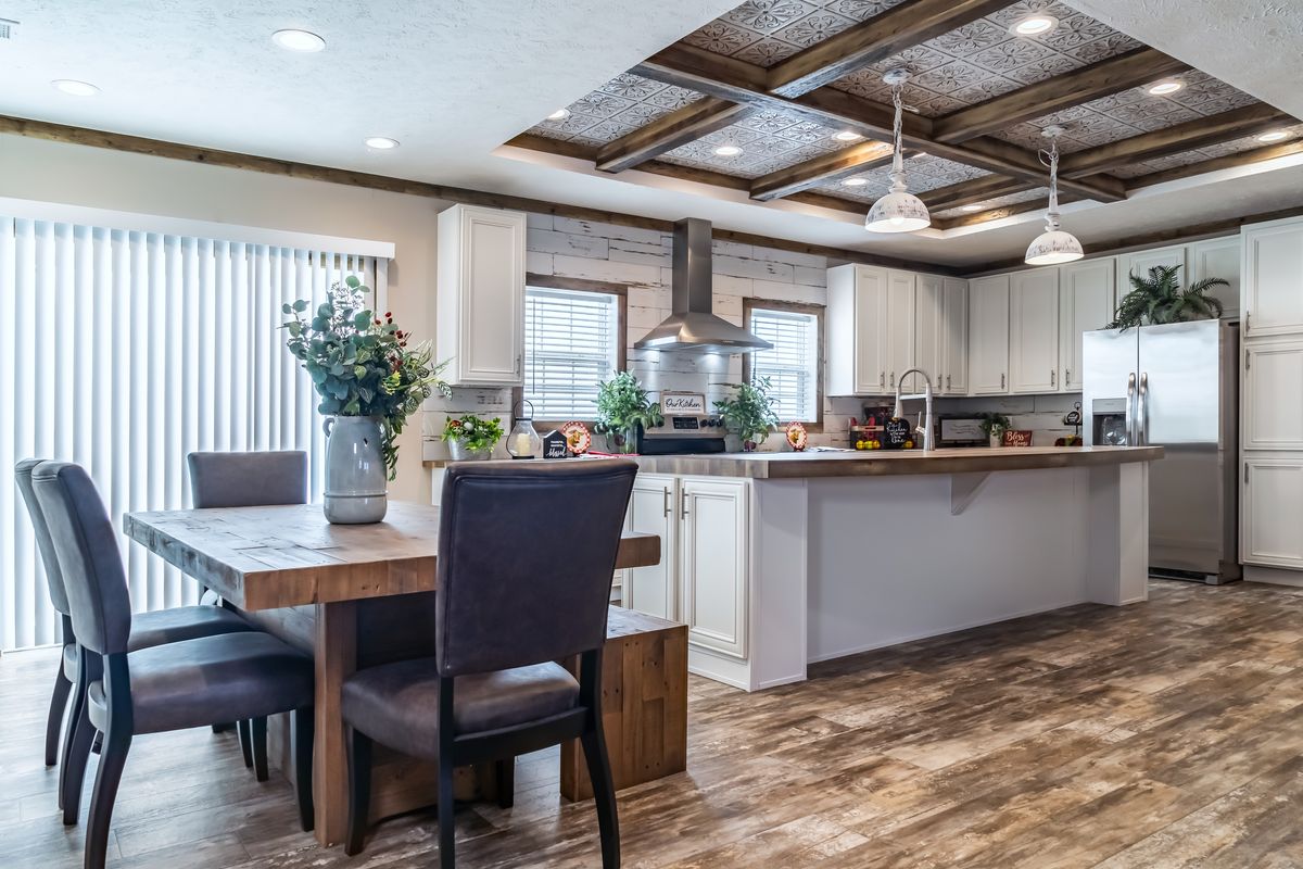 A kitchen with hardwood floors and wood ceilings.