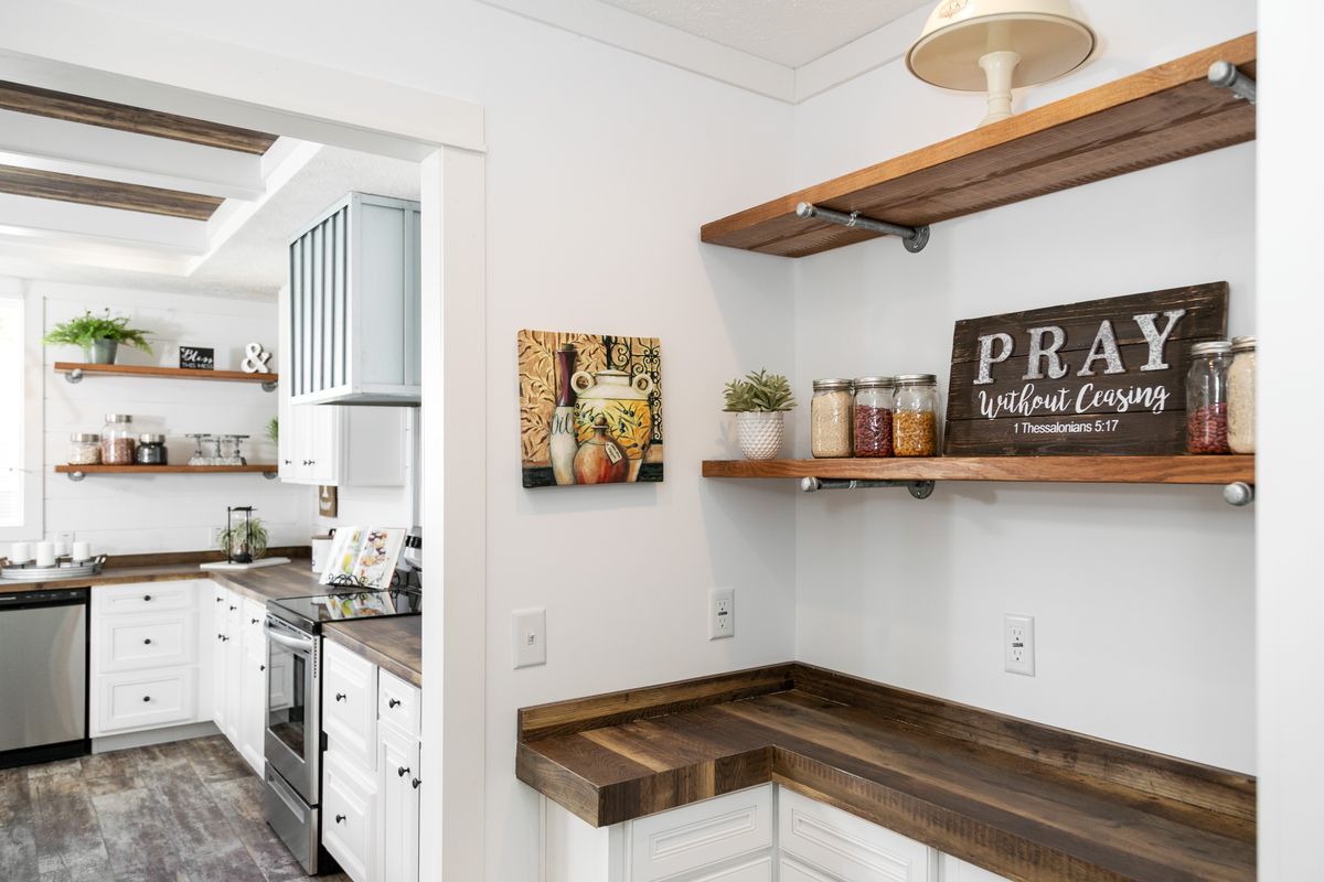 A kitchen with wooden shelves and wooden counter tops.