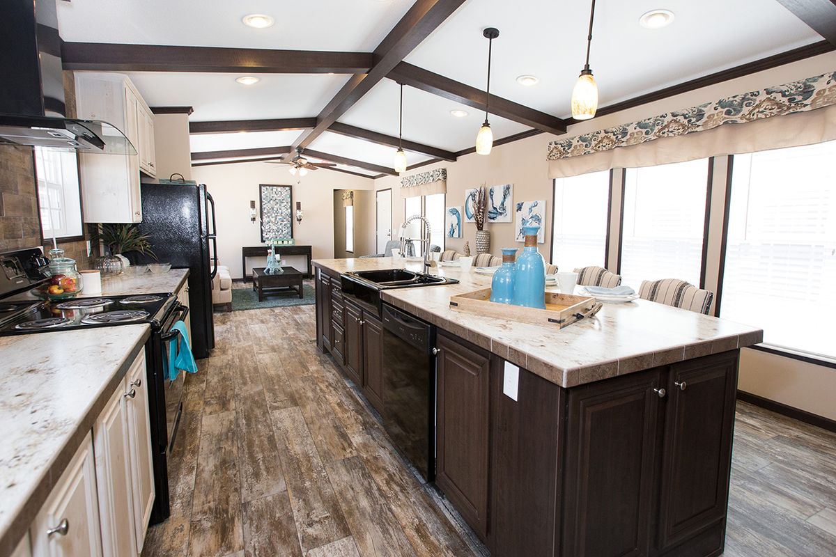 null A kitchen in a mobile home with hardwood floors.
