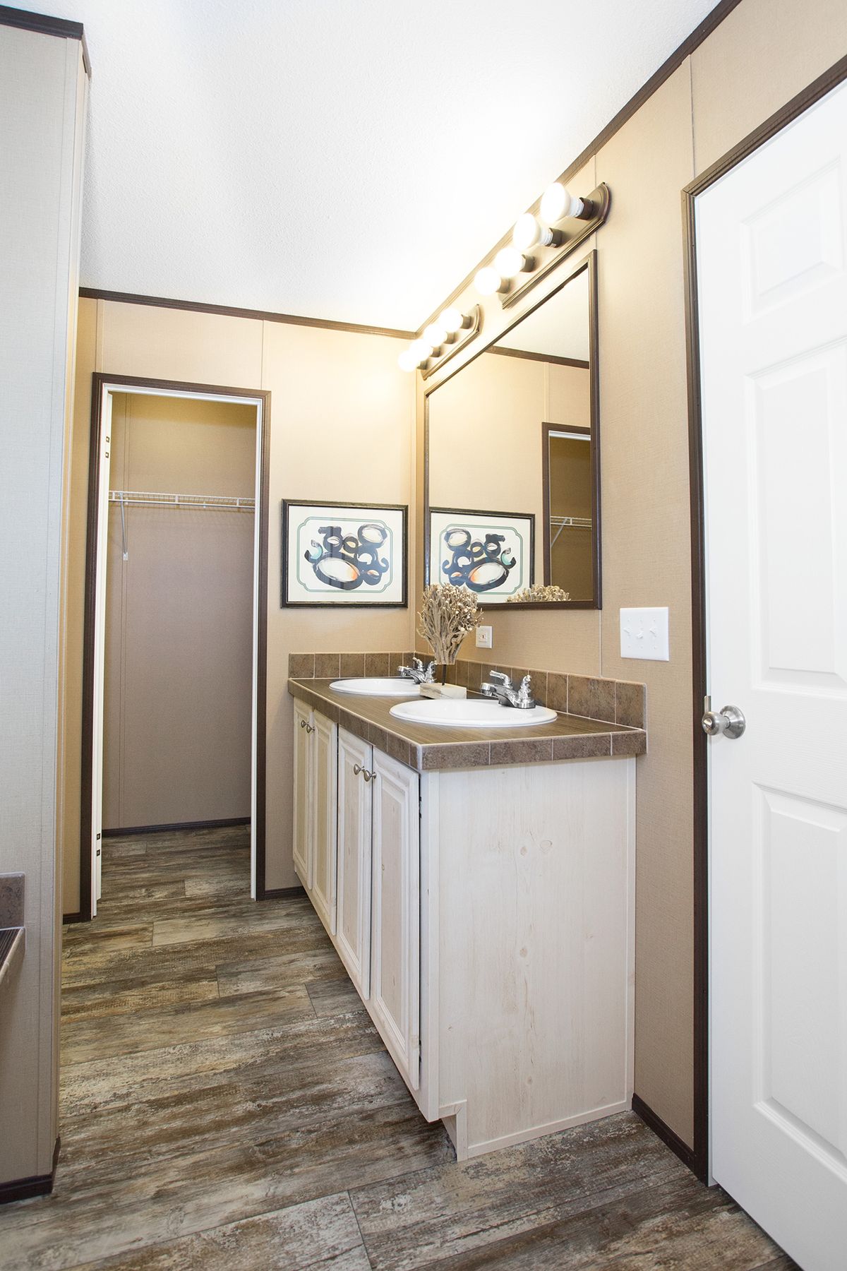 null A bathroom with two sinks and a mirror.