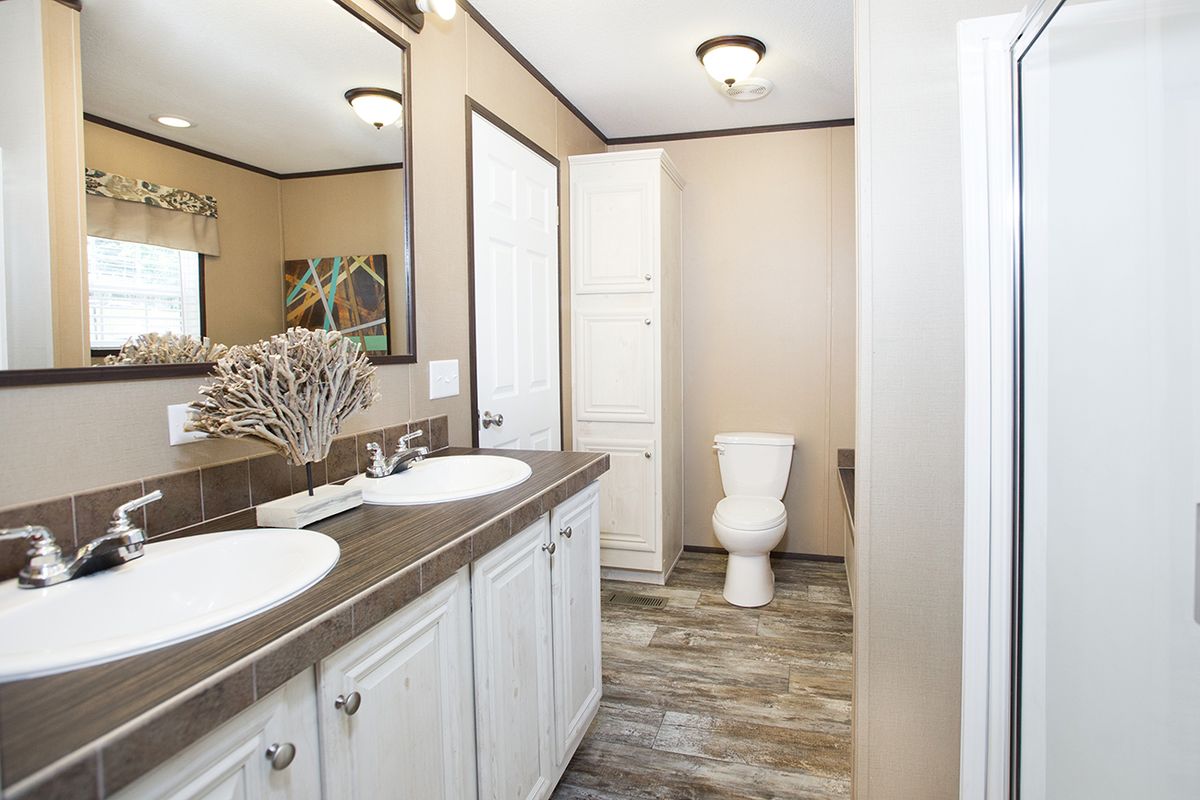 null A bathroom with two sinks and a toilet.