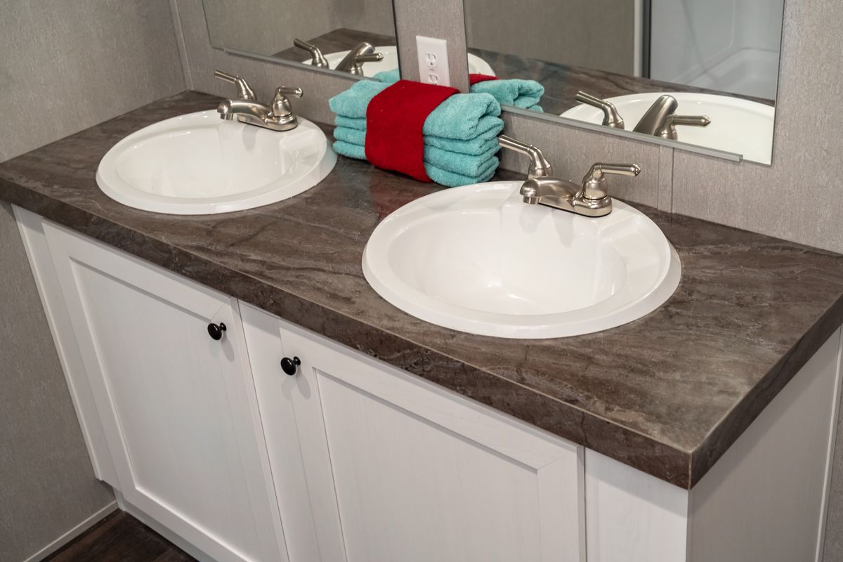A bathroom with two sinks and a mirror for enhanced functionality and convenience.