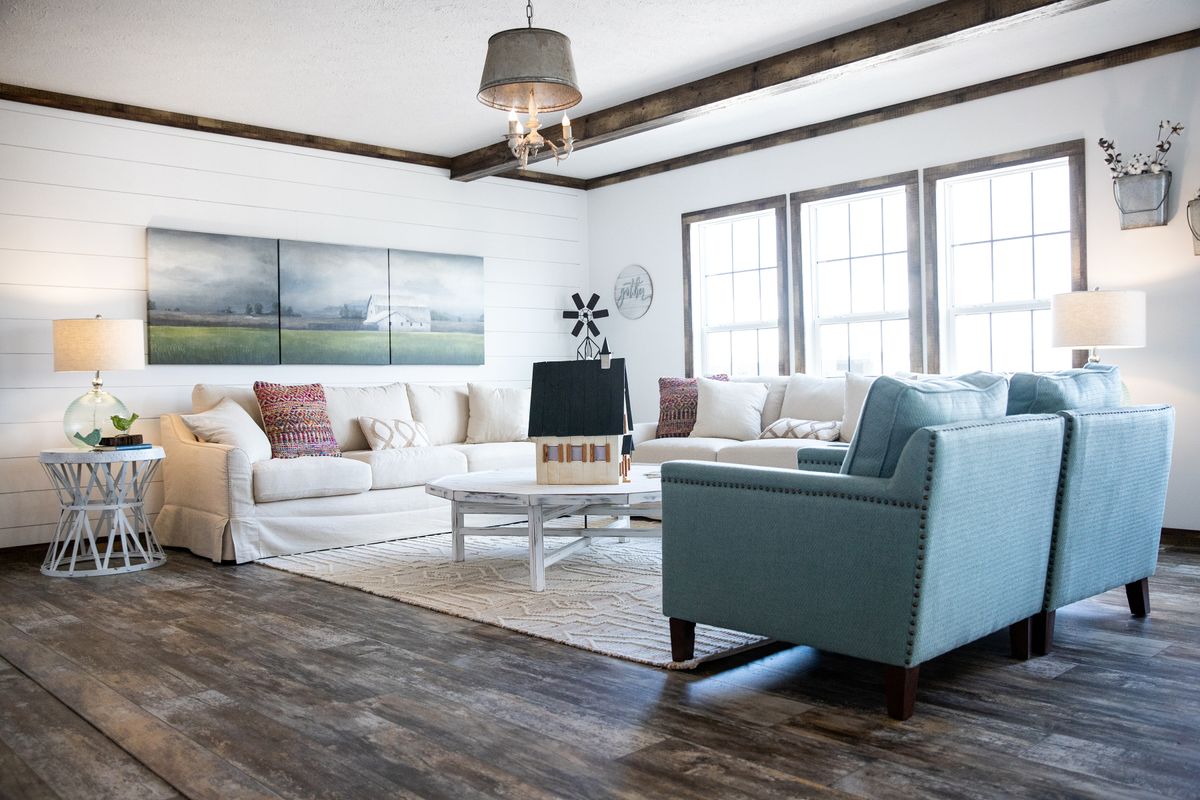 A living room with white walls and wood floors.