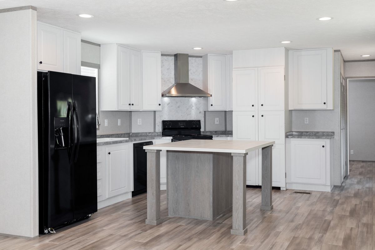 5fe78855-796f-4d64-ac0b-b45accf0d08d White kitchen, black appliances, hardwood floors.
