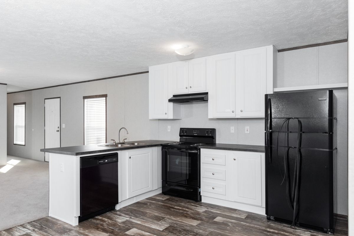 61eeeee5-bf8e-4311-842f-498c07e971e3 A kitchen with white cabinets and black appliances.