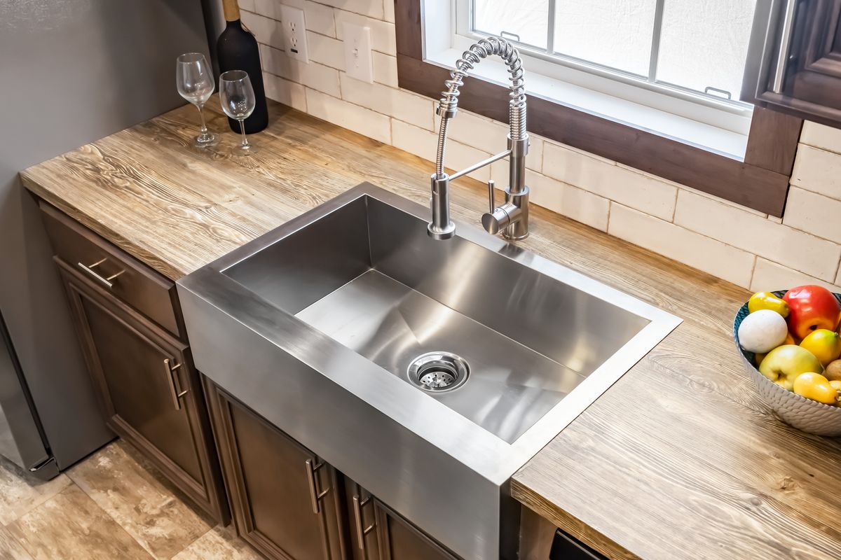 A kitchen with a stainless steel sink.