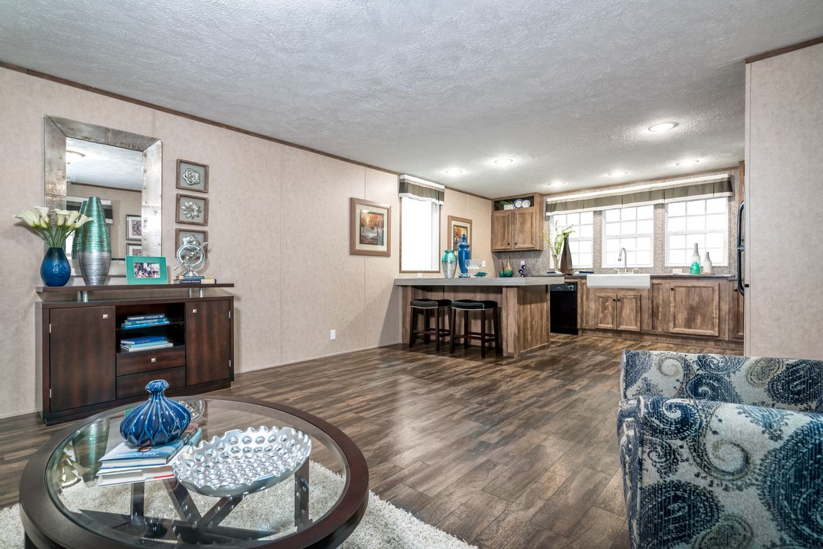 A living room and kitchen in a mobile home.