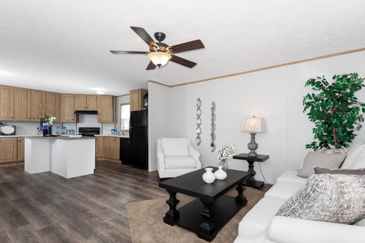 67c0c9a7-d615-48d7-848b-aa2dbb503a1e A living room with hardwood floors and a ceiling fan.