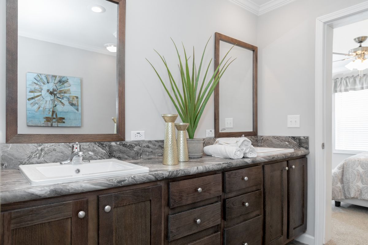 6c2a0360-d34c-4ada-987b-e0027d83fd30 A bathroom with two sinks and a mirror.