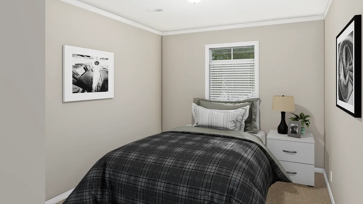 6fbff5d7-a0b0-41a1-9b08-0e6afc762f2a A small bedroom with a bed and dresser.