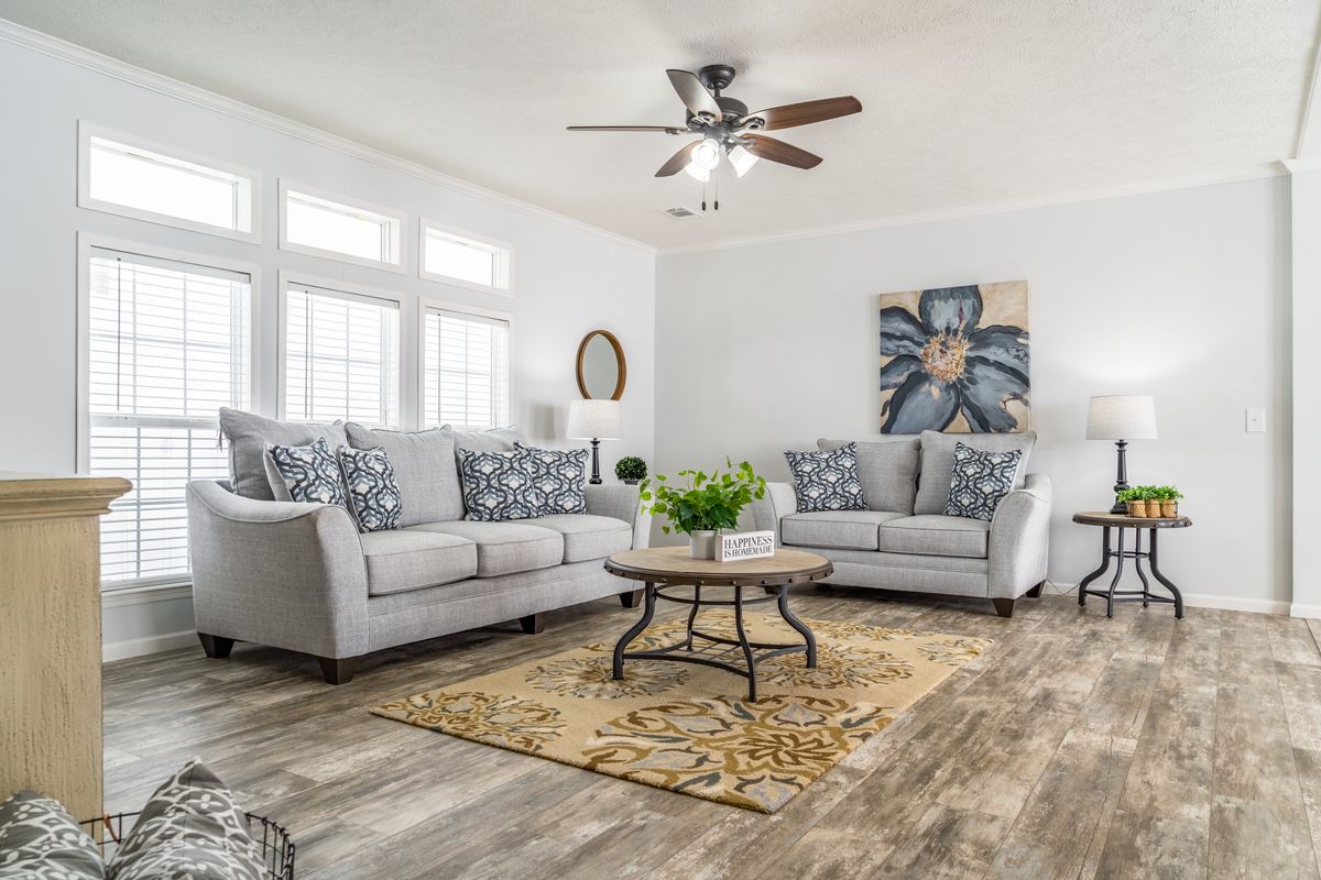 73c9ce49-512e-40ea-aa6c-f494d96f1805 A living room with hardwood floors and a ceiling fan.