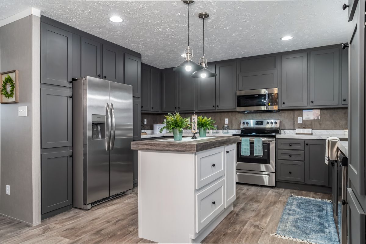 762fdf7c-c396-46b8-8b4a-d91d6674ad01 A kitchen with gray cabinets and stainless steel appliances.