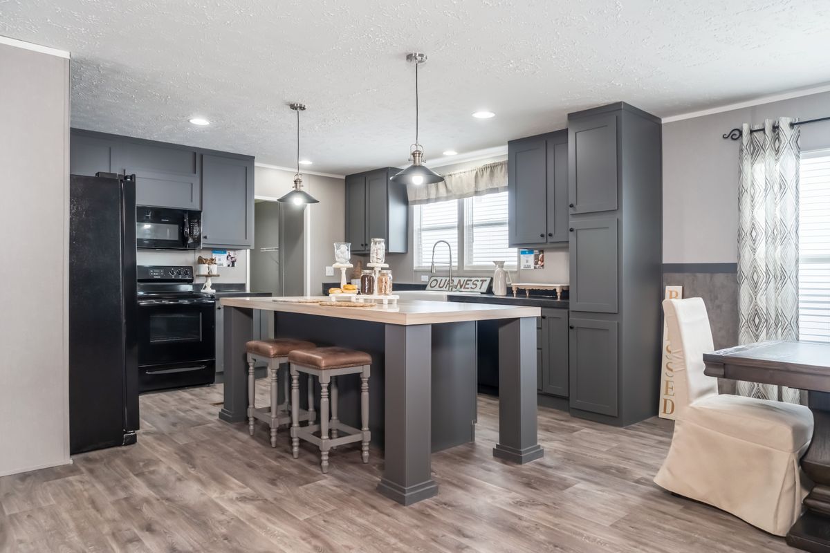 7b5f2a29-0533-4acf-abf3-815ef0255e91 A kitchen with sleek gray cabinets and warm hardwood floors.