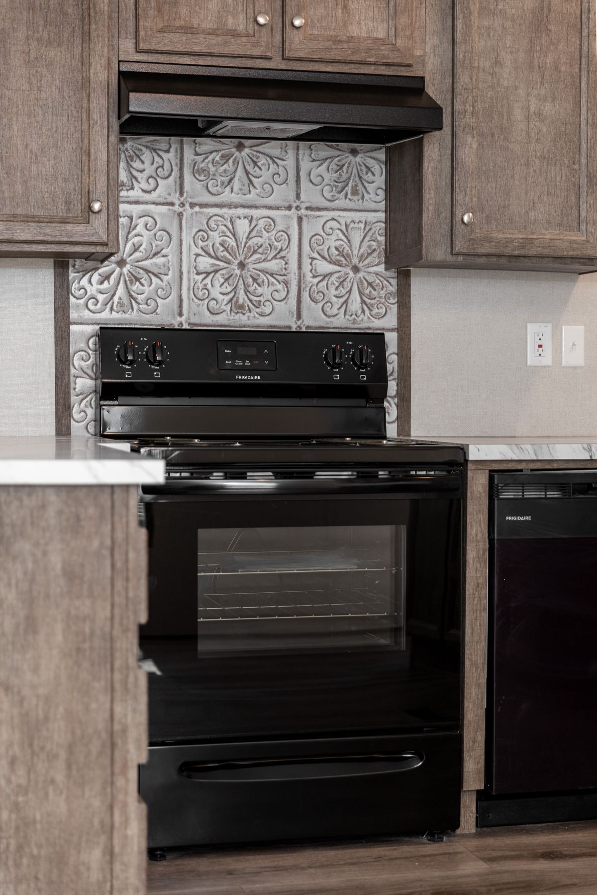 7e4e31a0-bd95-4fed-9d54-ab8a78533495 A kitchen with black appliances and wood cabinets.