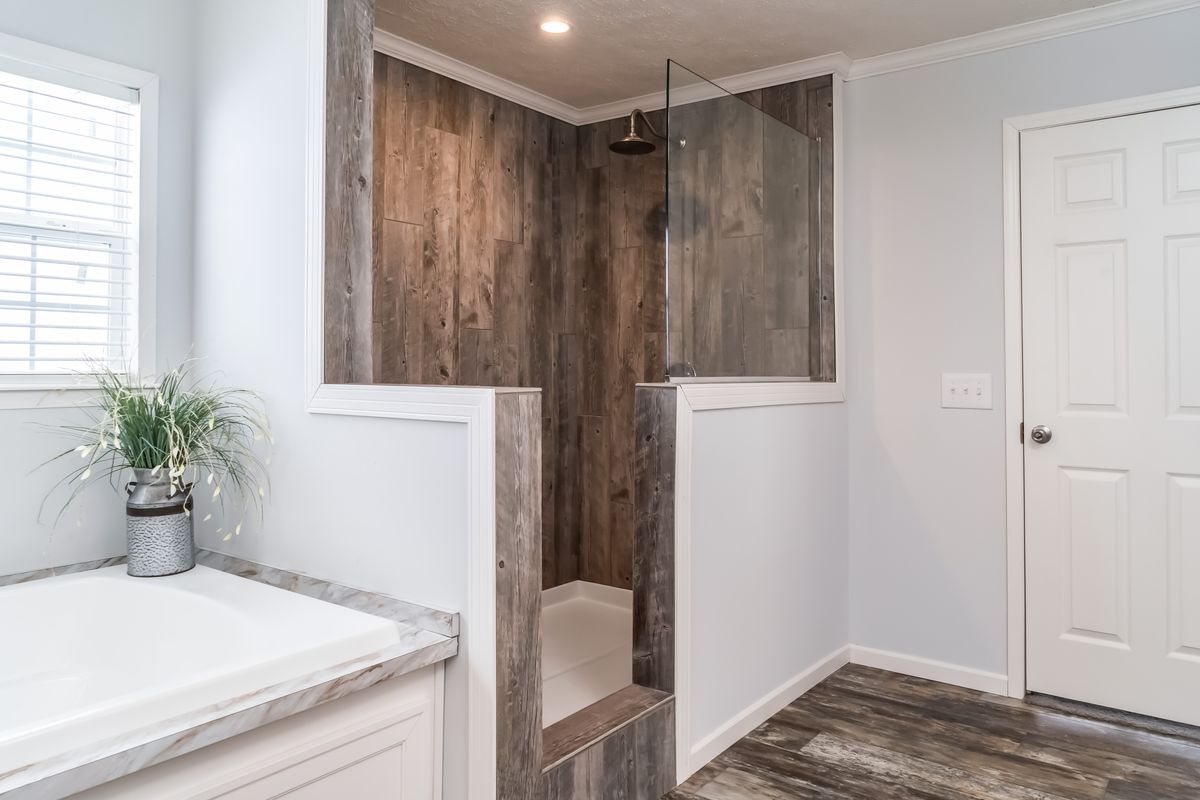 30CEE16682AH
Clayton Waycross Facility 930 A bathroom with wood floors and a shower.