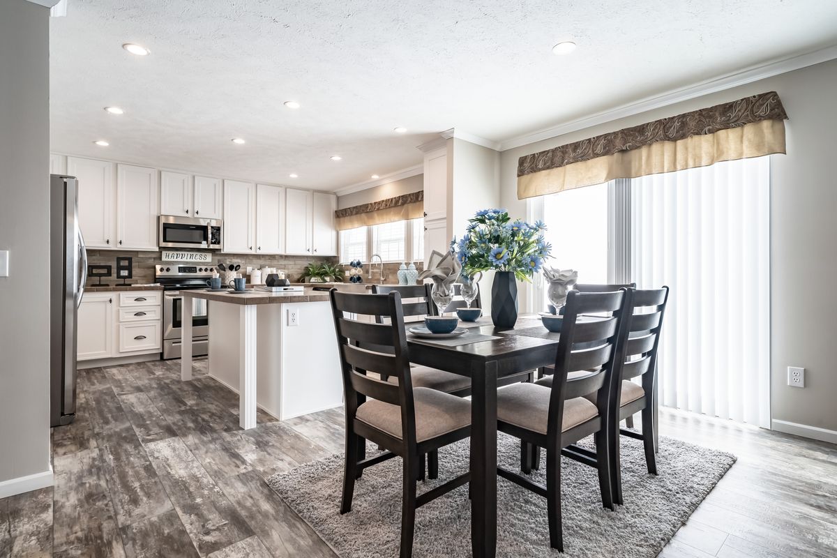 A kitchen and dining room with hardwood floors.