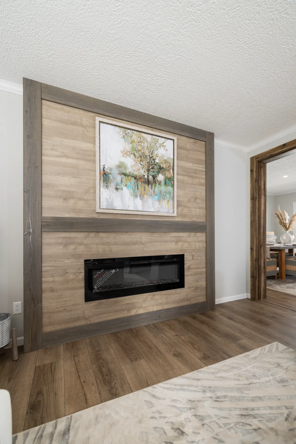 A living room with hardwood floors and a fireplace.