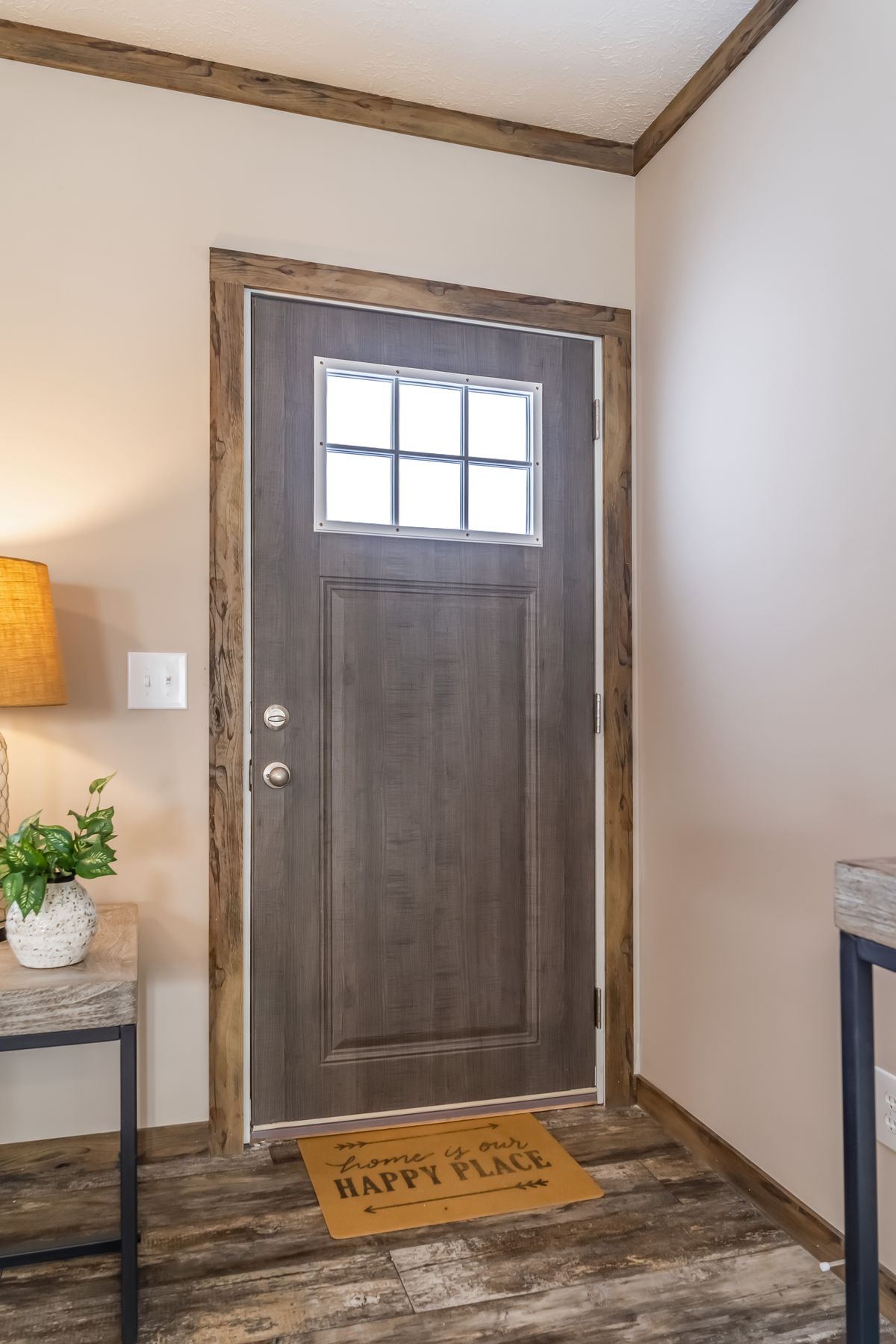 The front door of a home with wood floors.