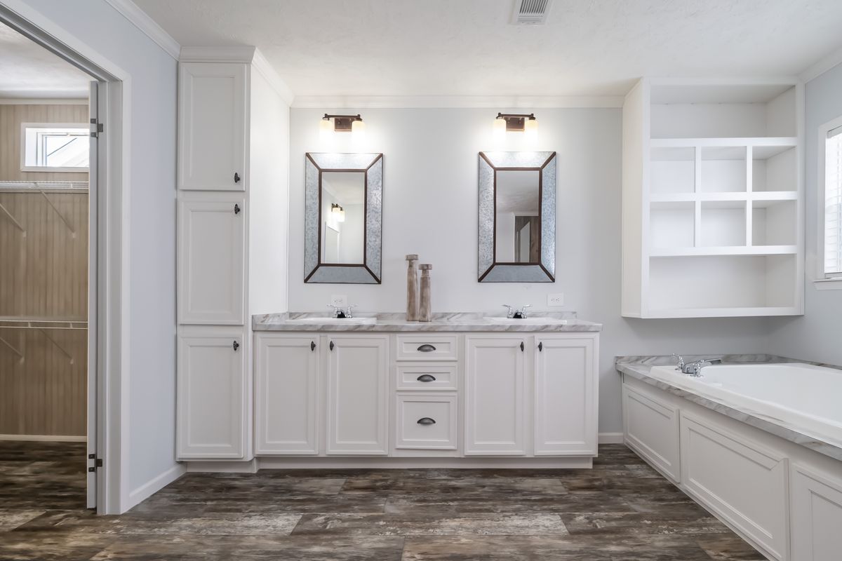 30CEE16682AH
Clayton Waycross Facility 930 A bathroom with white cabinets and wood floors.