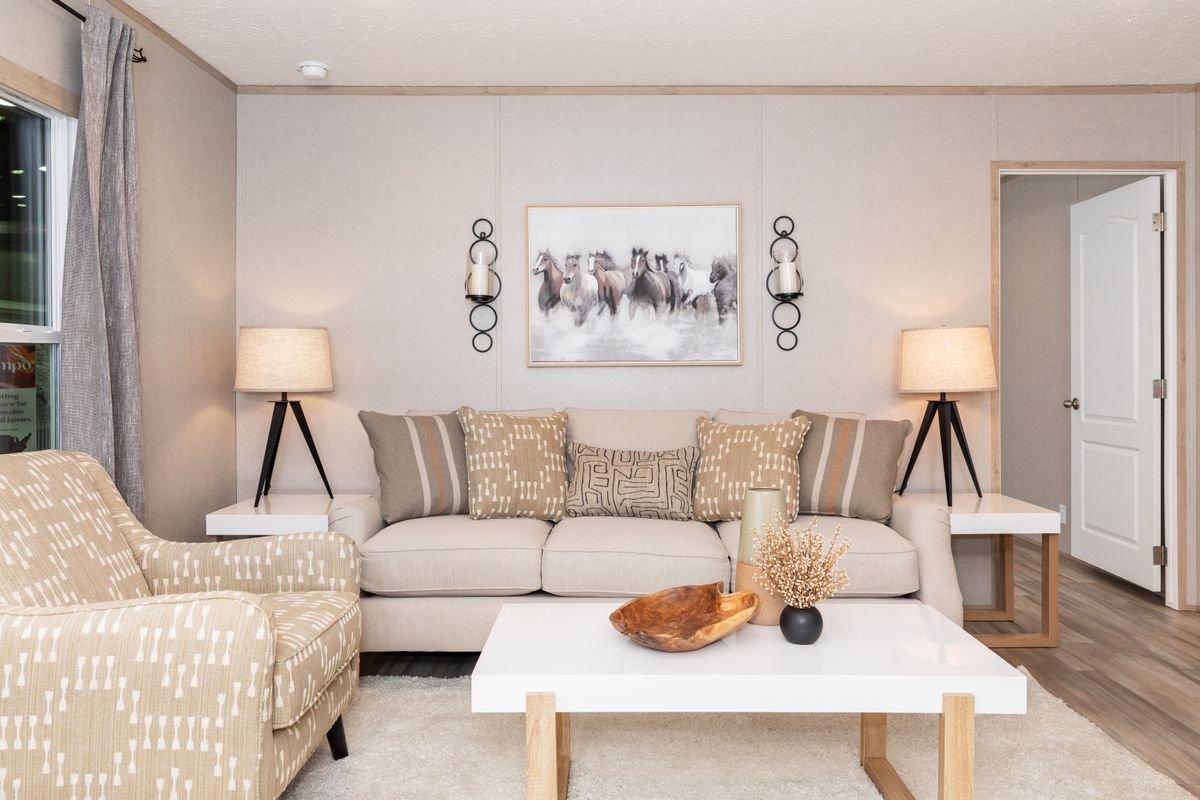 9feadc7d-5b4c-43a0-be11-87cf733ca778 A living room in a mobile home with beige furniture.