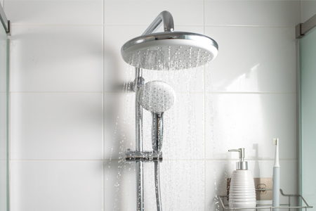 White shower walls and white shower head
