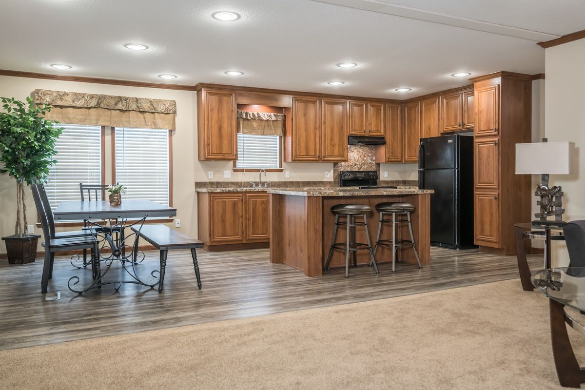 A living room and kitchen in a mobile home.