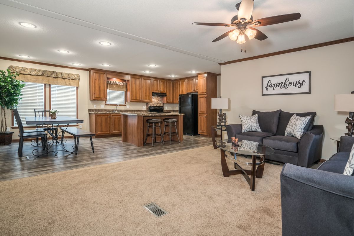 A living room and kitchen in a mobile home.